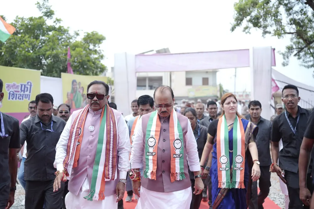 Leaders in tricolour scarves walking to a public meeting