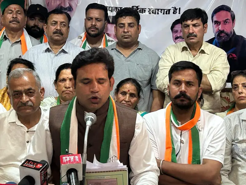 A press conference with several people seated behind microphones