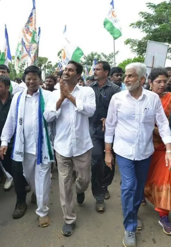 Leaders and supporters walking together along a road beneath flags